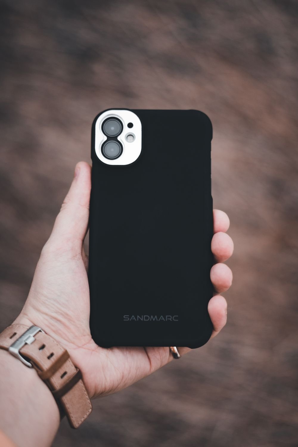 Phone in black protective case outdoors